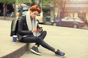 Young woman using mobile on the street / Young woman using mobile telephone on the street