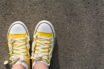 Yellow sneakers decorated with daisies