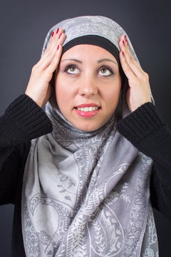 Muslim woman adjusting her headscarf