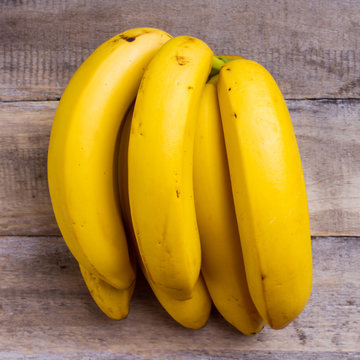 yellow bananas on wooden background