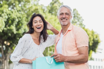 Portrait of happy couple with shopping bags