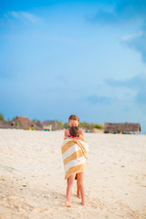 Girls wrapped in towel at tropical beach in the evening