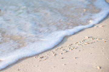 Holidays summer concept. The word summer written in the sand