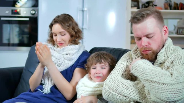 a family of father, mother and the boy got sick, sneezing without end