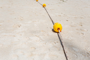 Yellow buoy on the beach