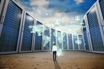 Composite image of rear view of businessman with hands in pocket