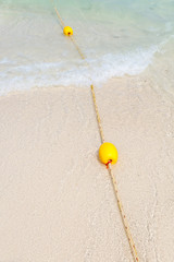 Naklejka premium Yellow buoy on the beach