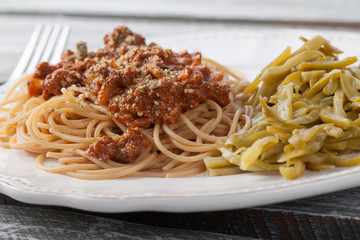 Whole wheat spaghetti with French style cut green beans close shot