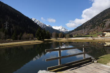 Fototapeta na wymiar lago laghetto di montagna neve riflesso 