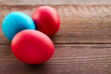 Fototapeta na wymiar Painted colorful easter eggs on rustic wooden background