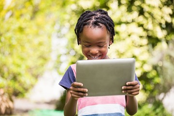 Fototapeta premium A little Boy is using a tablet