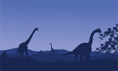 Silhouette of brachiosaurus with blue backgrounds