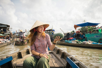 Woman tourist on floating market in Vietnam