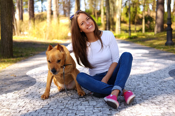 Casual brunette female with her brown dog.