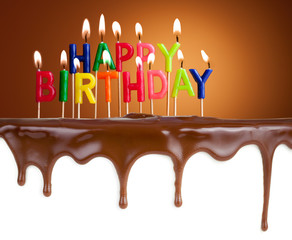 Happy birthday lit candles on chocolate cake 