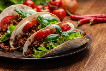 Mexican tacos with minced meat, beans and spices