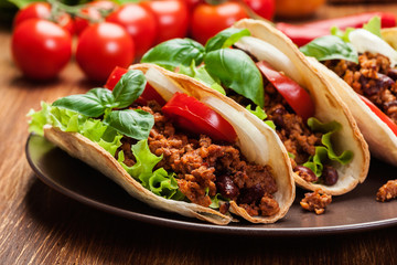Mexican tacos with minced meat, beans and spices