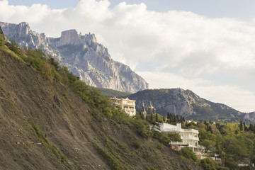Naklejka premium background landscape view of the Alupka, churches and villas, amid mountains Ai-Petri in Crimea