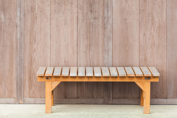 Wood bench in front of wooden house