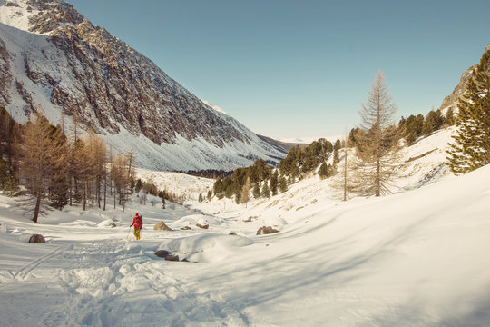 Man hiking in mountain landscape outdoor. Winter sport, walking and trekking in mountains