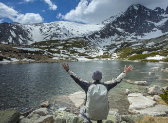 a man near a lie in mountains