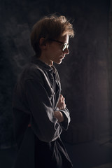 Dark studio Profile portrait of young thinking man