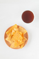 Tortilla chip , a snack food made from corn tortillas