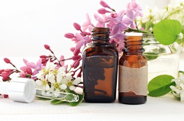Aromatherapy bottles with essential oils. Fresh blossom. Sweet floral scent.