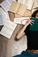 Young attractive man listening to books with headphones