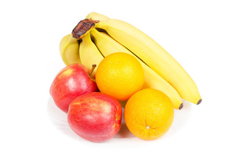 Red apples, oranges and bananas on white plate isolated on white background
