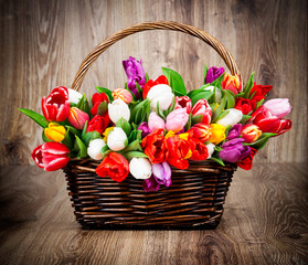 Fototapeta na wymiar Tulips on wooden background
