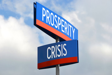 Prosperity and crisis street sign