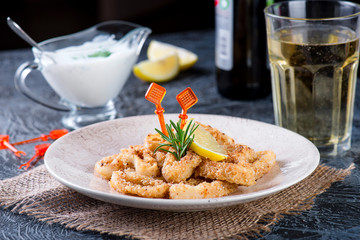 fried squid rings with lemon, greek yogurt