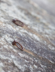 Metal ring climbing equipment at stone cliff