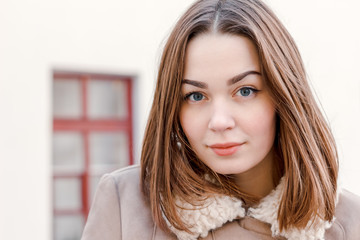 young attractive girl on the background of buildings