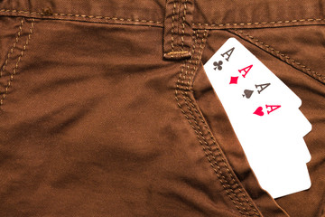 four ace cards inside brown jeans front pocket