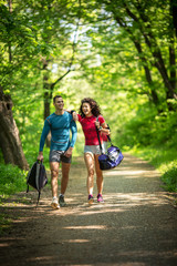 Fototapeta premium Young couple jogging at the park.Green environment.