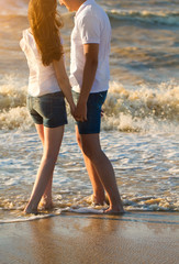 Happy young couple in love have fun on beautiful beach at beauti