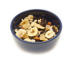 Dried fruits and nuts in bowl on a white background