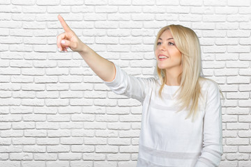 Young blond businesswoman pressing the touchscreen button