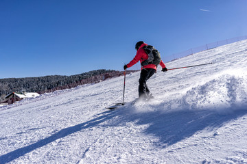 Fototapeta na wymiar Action shot of female skier on italian slopes.