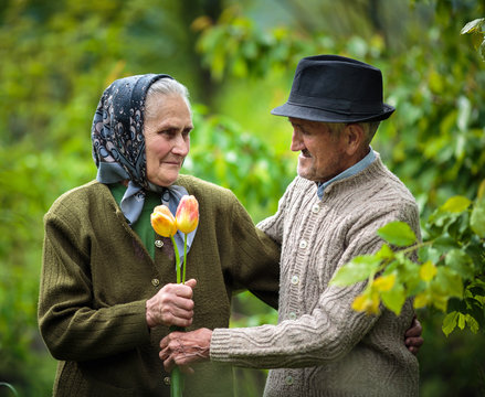 Old Man Giving Flowers To His Wife