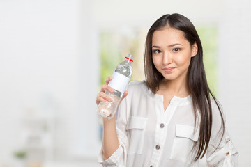 young woman showing a bottle of water