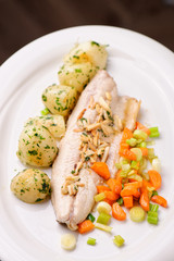 Closeup of fine dine dinner Plate with Grilled White Fish and Vegetables