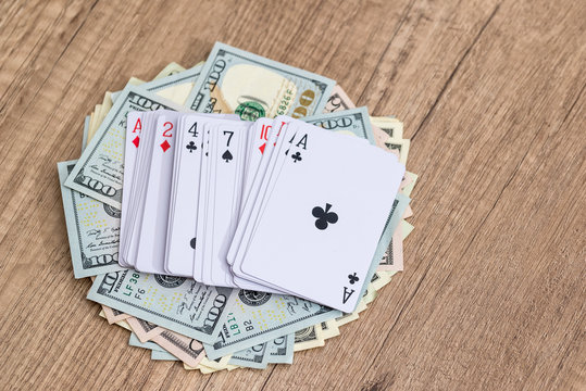 poker cards with dollar on wooden table