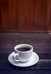 Cup of coffee with vintage background, vertical style