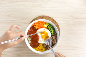 stiring bibimbap , korean dish