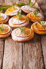 Tasty cookies with orange slices and mint vertical
