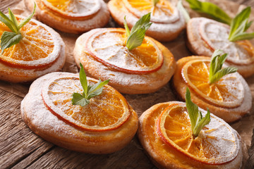 Tasty cookies with orange slices and mint close-up. horizontal
