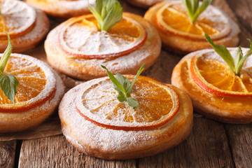 Freshly baked cookies with oranges and mint close-up. horizontal
